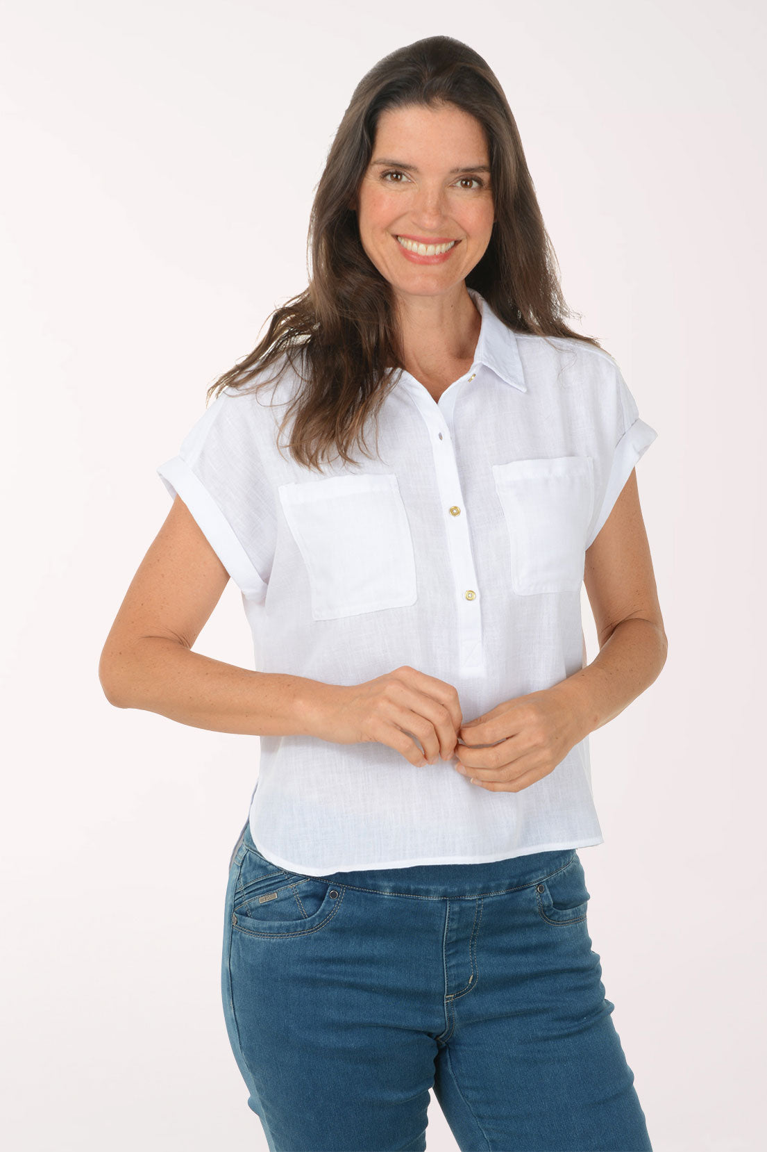 Woman wearing a white short-sleeve shirt and blue jeans on a white background