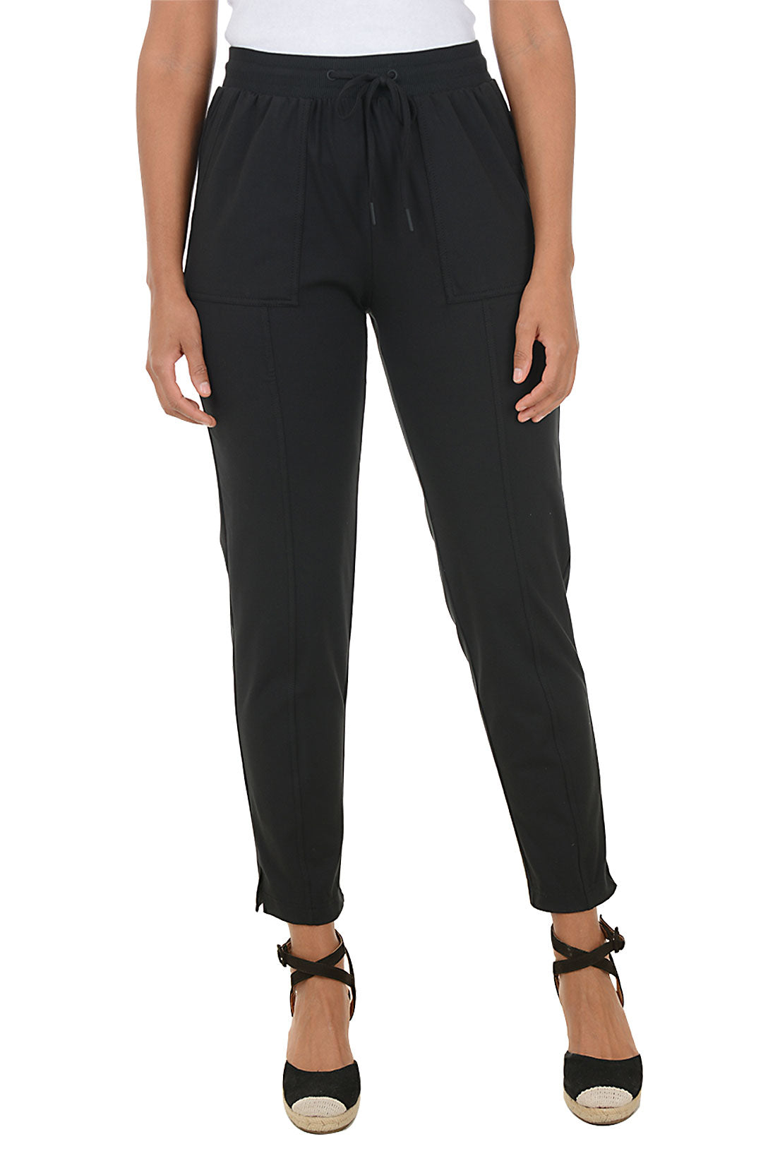 Black pants worn by a person on a white background.