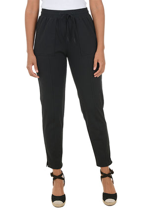 Black pants worn by a person on a white background.