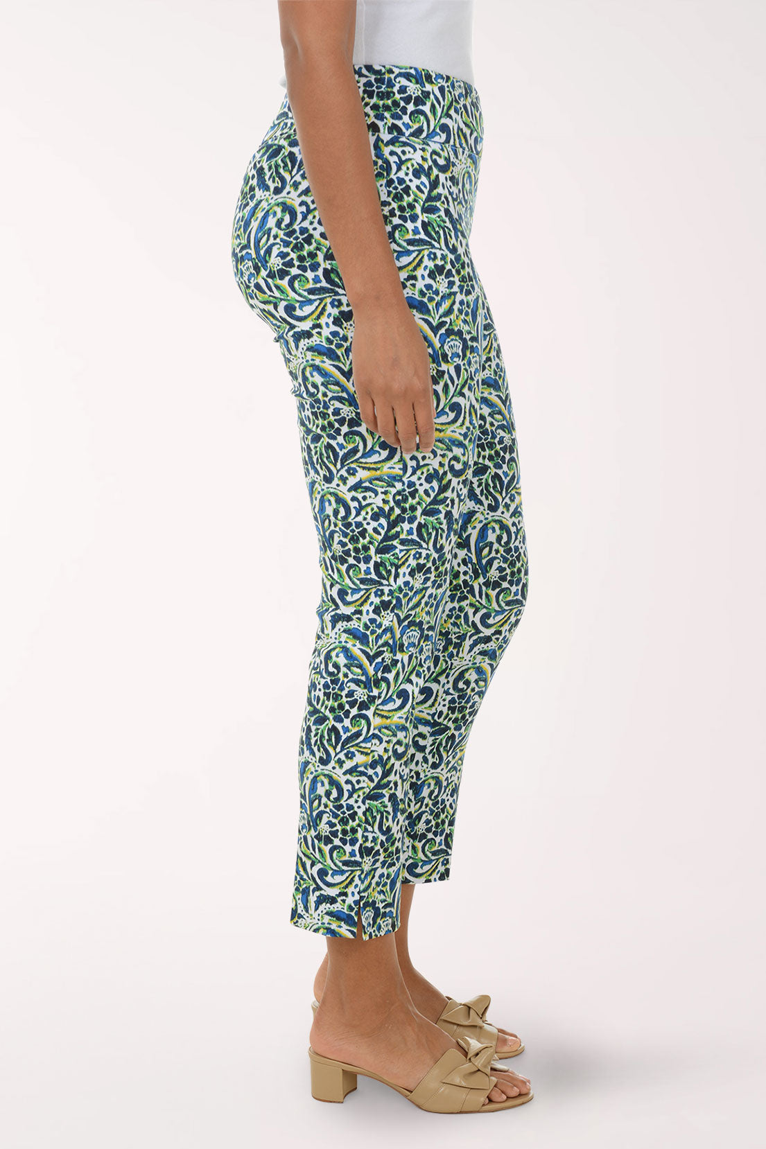 Woman wearing a patterned green and blue pants on a white background
