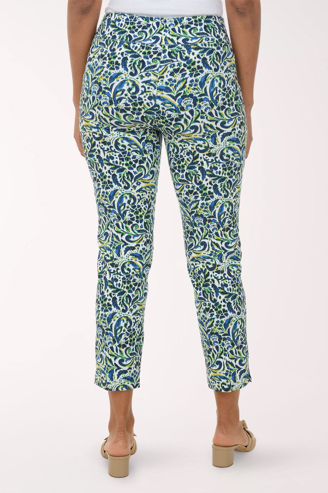Woman wearing a patterned green and blue pants on a white background