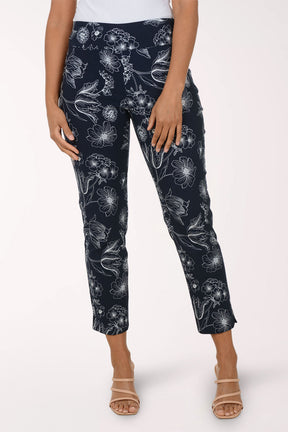 Navy pants with white floral pattern worn by a person on a white background