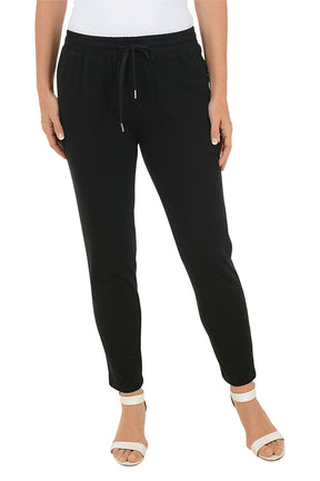 Black jogger pants worn by a person on a white background