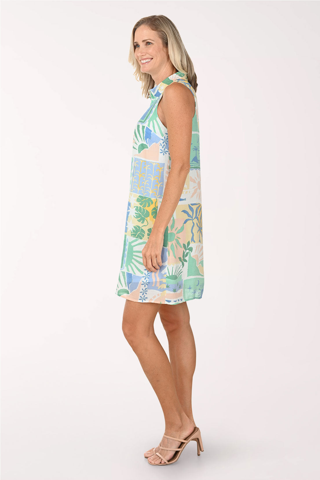 Woman wearing a colorful patterned dress on a white background