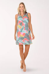 Woman wearing a colorful tropical leaf pattern dress on a white background