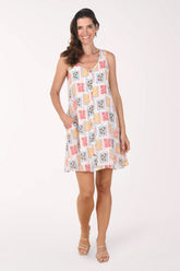 Woman wearing a patterned dress on a white background
