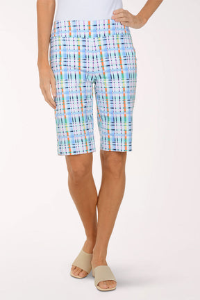 Person wearing colorful plaid shorts on a white background