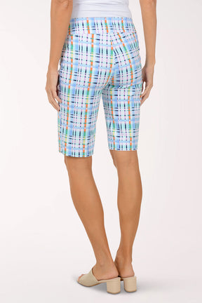 Person wearing colorful plaid shorts on a white background
