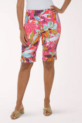 Person wearing colorful floral shorts on a white background
