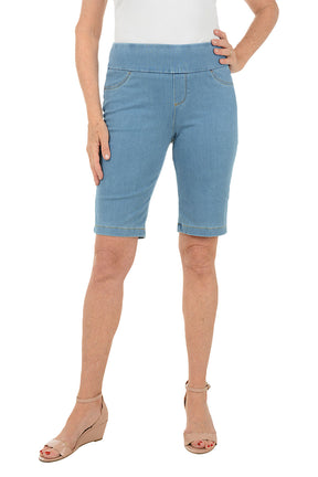 Person wearing light blue denim shorts on a white background