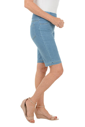 Person wearing light blue denim shorts on a white background