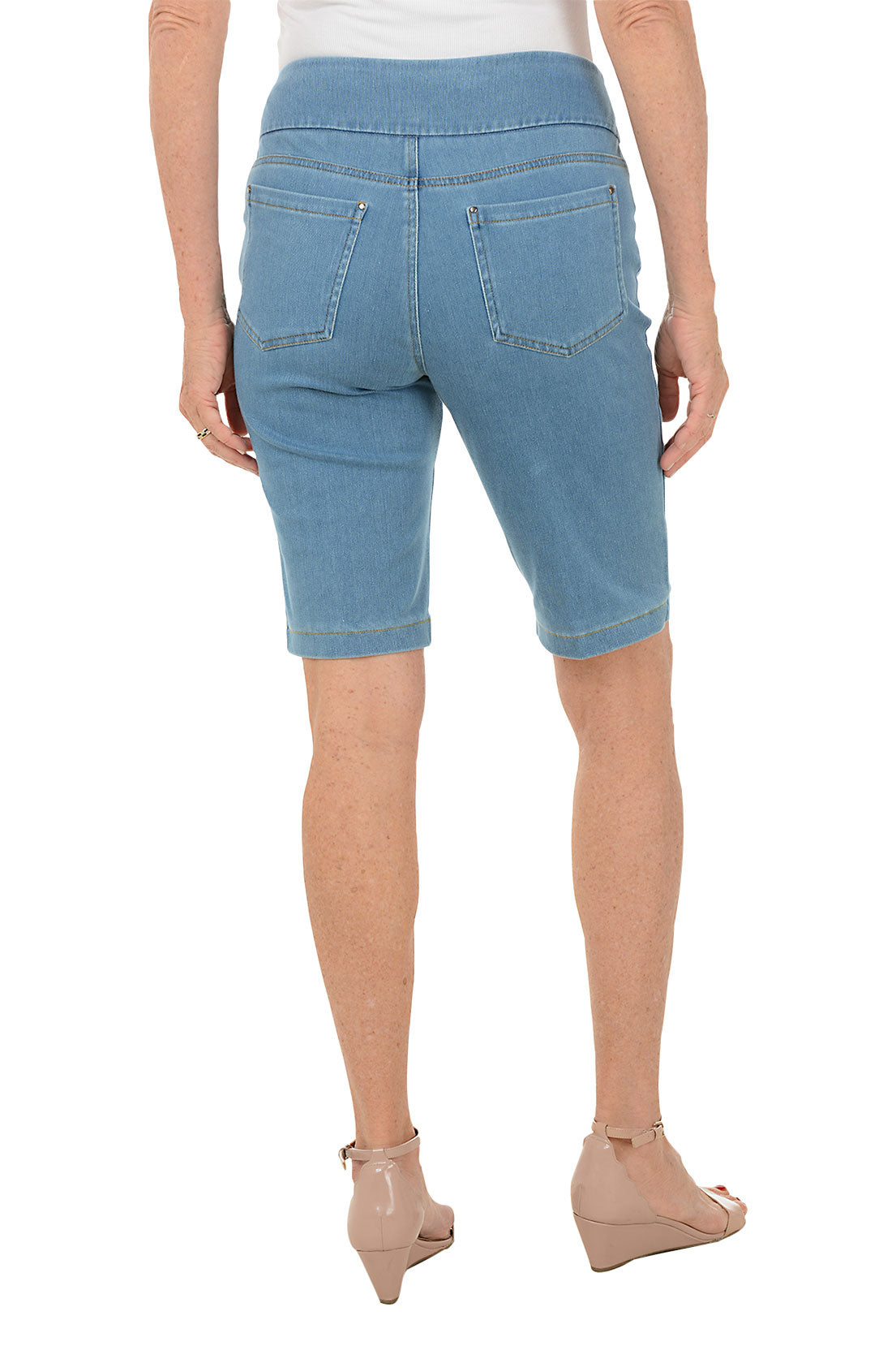 Person wearing light blue denim shorts on a white background