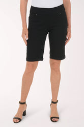 Person wearing black shorts on a white background