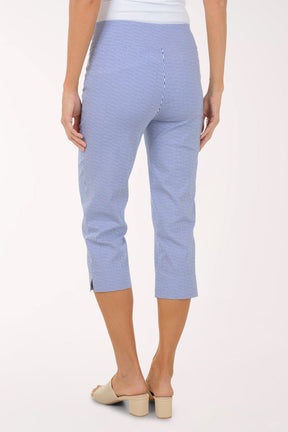 Person wearing blue checkered pants on a white background