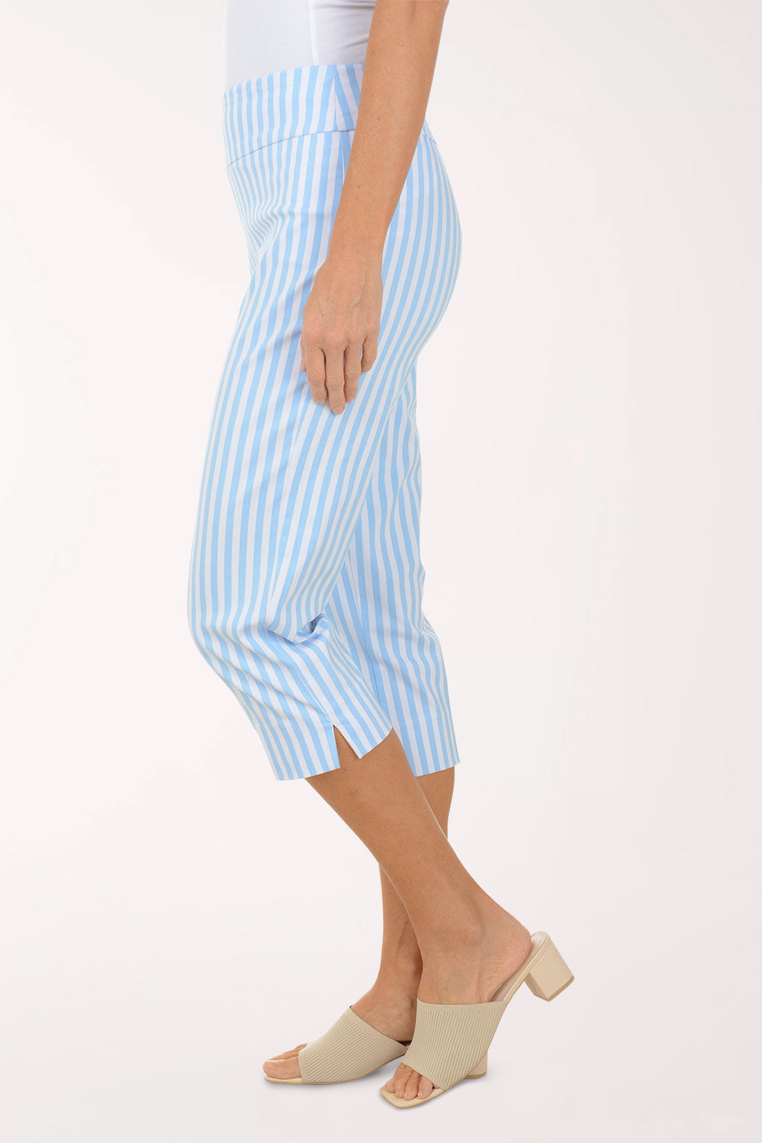 Person wearing light blue and white striped pants on a white background