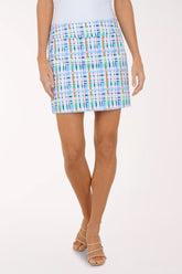 Person wearing a colorful plaid skirt on a white background