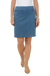 Woman wearing a light wash blue denim skirt on a white background.