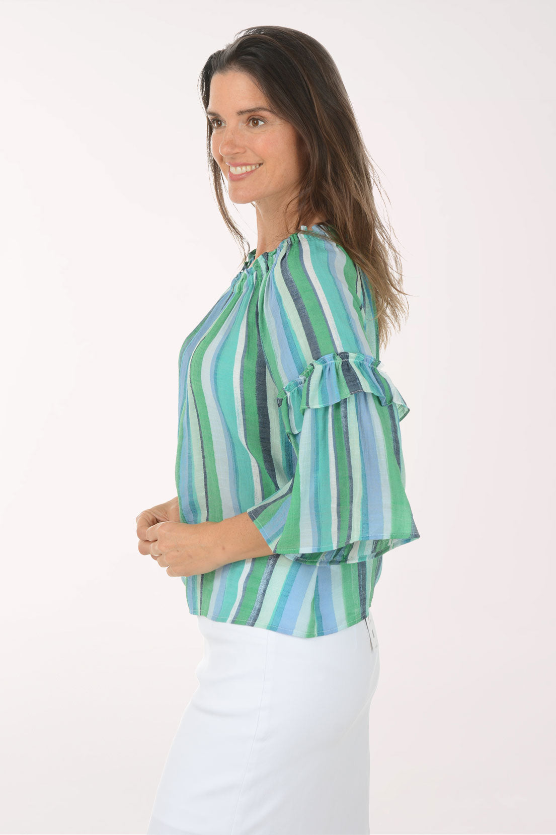 Woman wearing a green and blue striped blouse on a white background