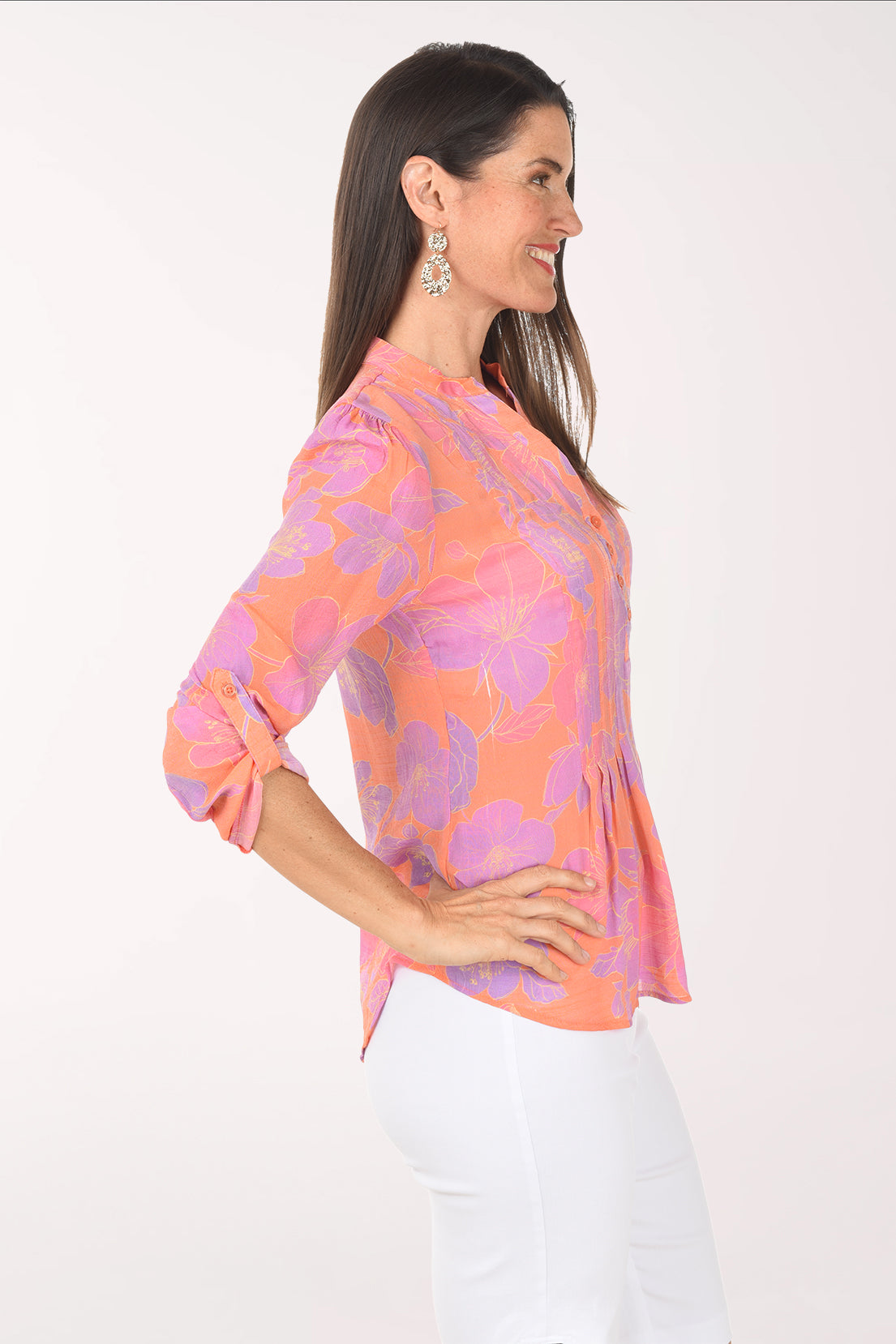 Woman wearing a colorful blouse with a white background