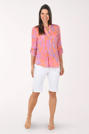 Woman wearing a colorful blouse with a white background