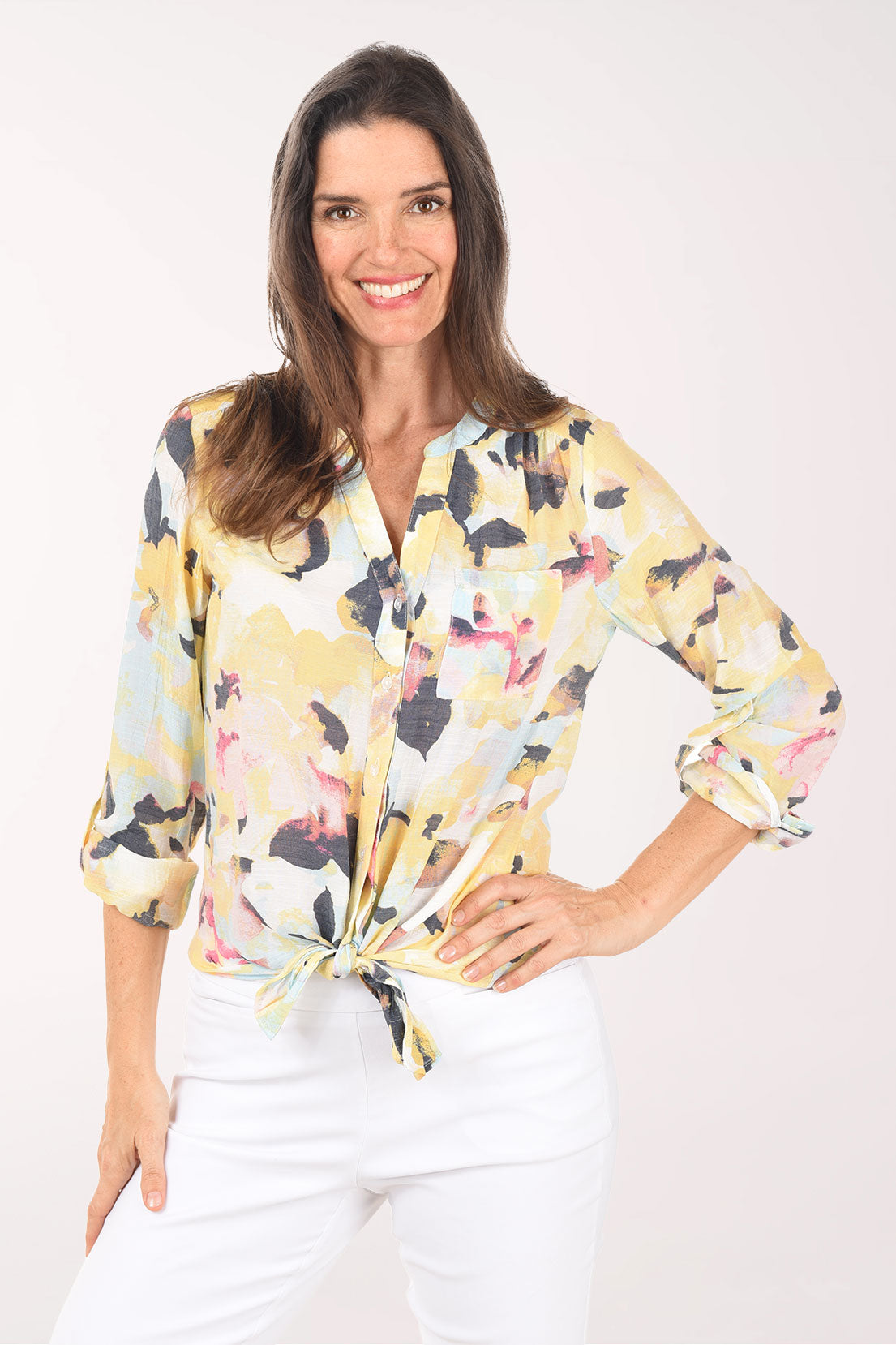 Woman wearing a floral blouse with a white background
