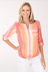 Woman wearing a pink and orange striped blouse on a white background