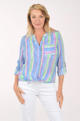 Woman wearing a colorful striped shirt on a white background