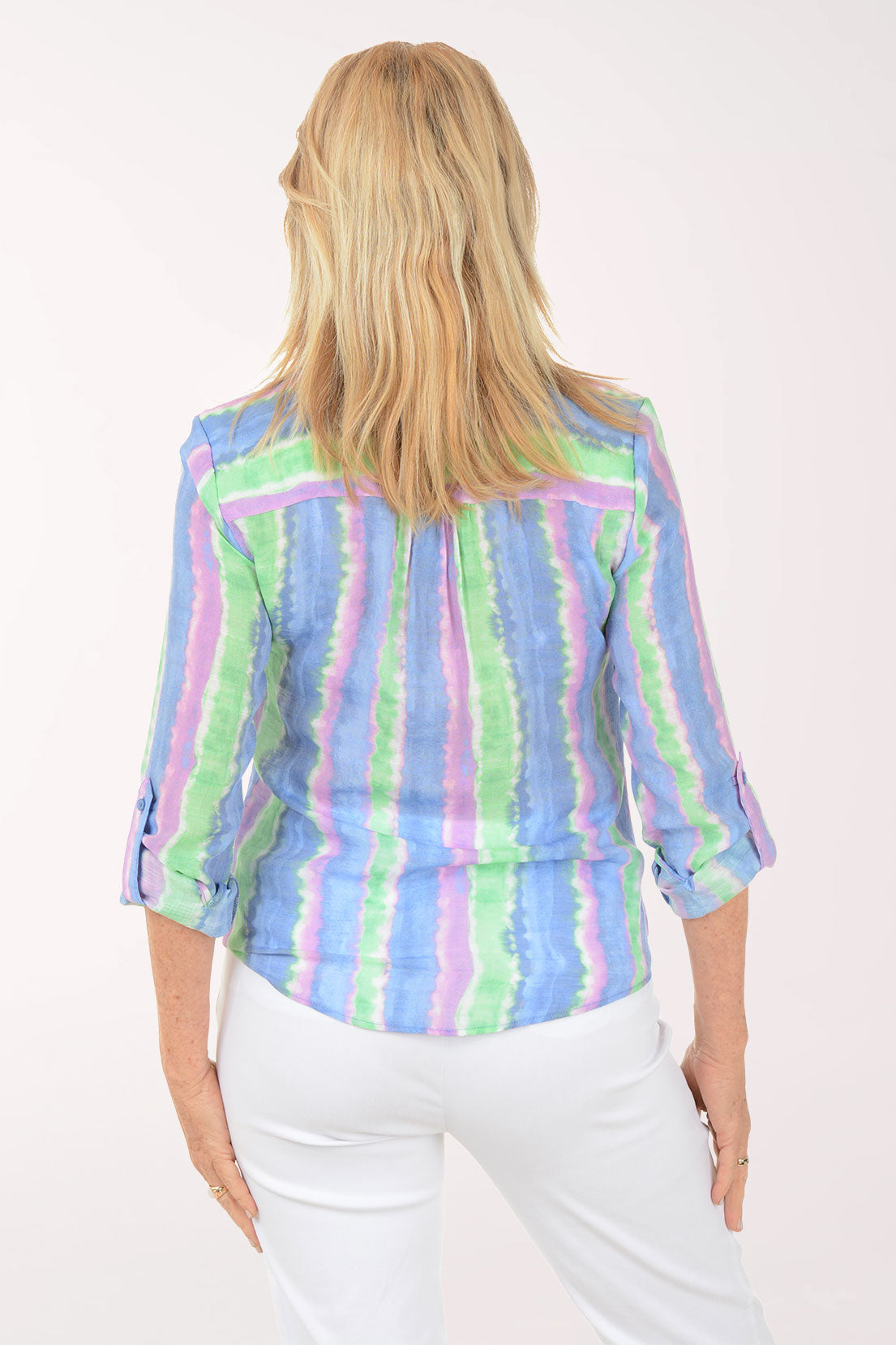 Woman wearing a colorful striped shirt on a white background