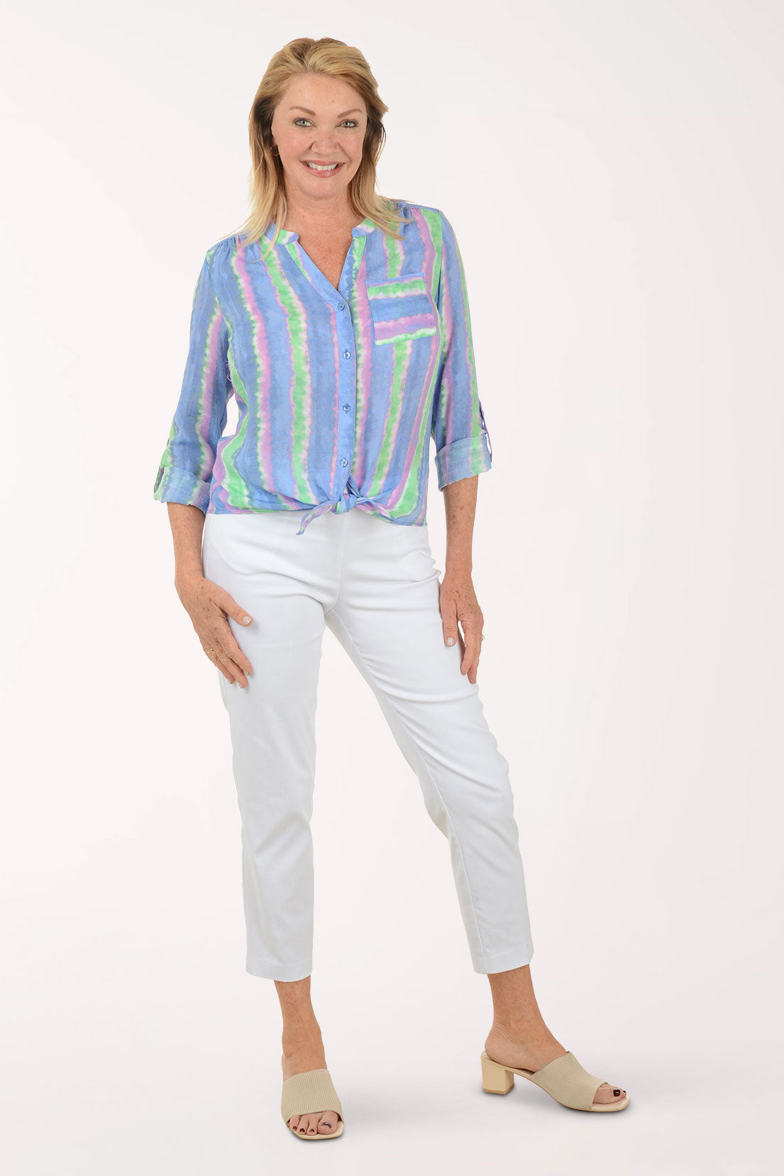 Woman wearing a colorful striped shirt on a white background