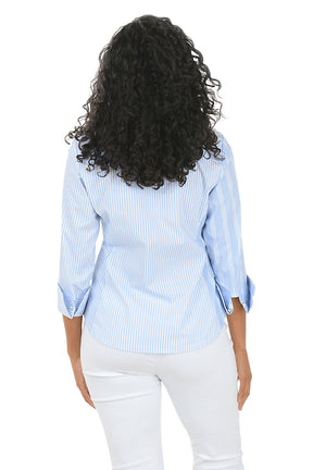 Woman wearing a light blue striped shirt and white pants on a white background. Back shot.