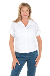 Woman wearing a white shirt and blue jeans on a white background.