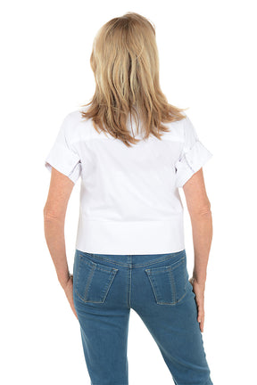 Woman wearing a white shirt and blue jeans on a white background. Back shot.