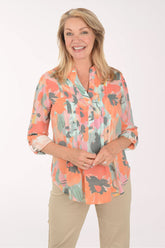 Woman wearing a floral blouse with a white background
