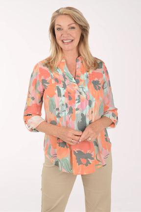Woman wearing a floral blouse with a white background