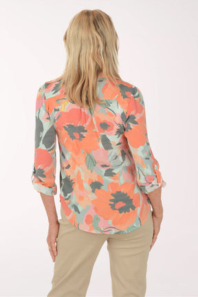 Woman wearing a floral blouse with a white background