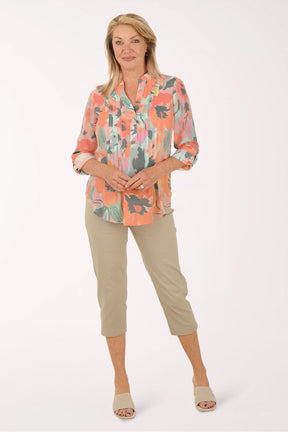 Woman wearing a floral blouse with a white background
