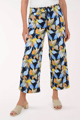 Floral-patterned pants worn by a person on a white background