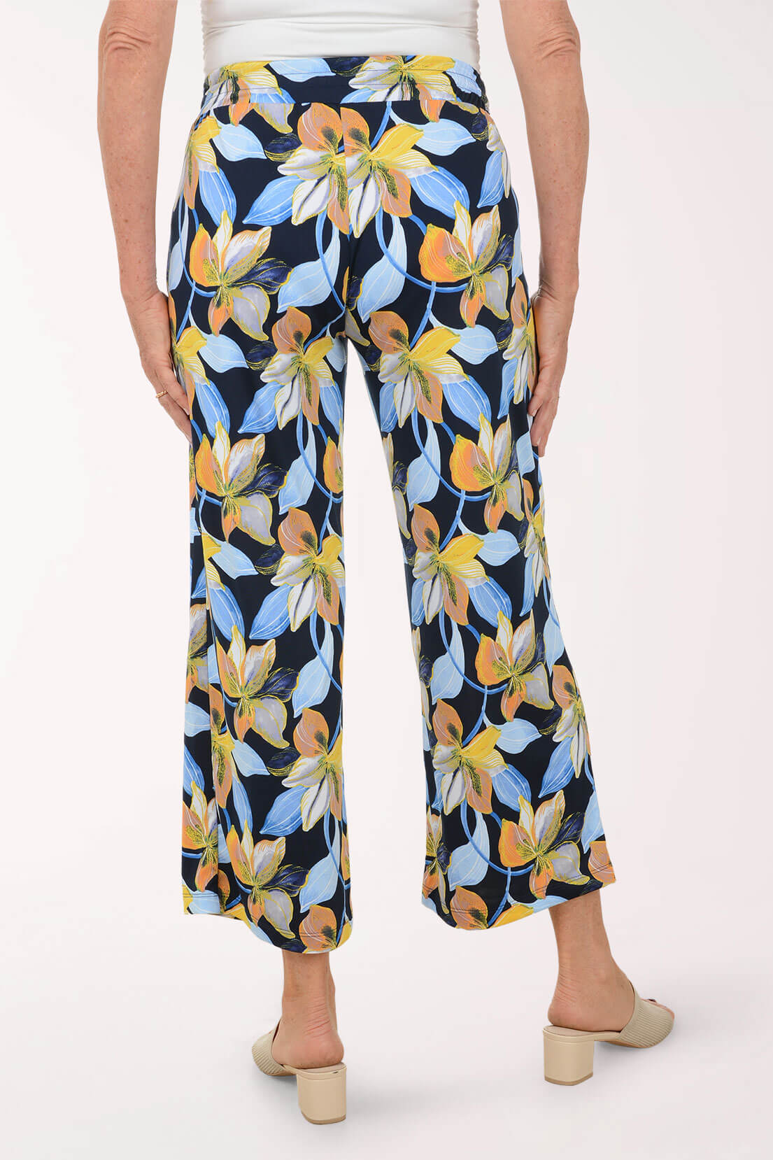 Floral-patterned pants worn by a person on a white background