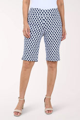 Person wearing navy and white patterned shorts on a white background