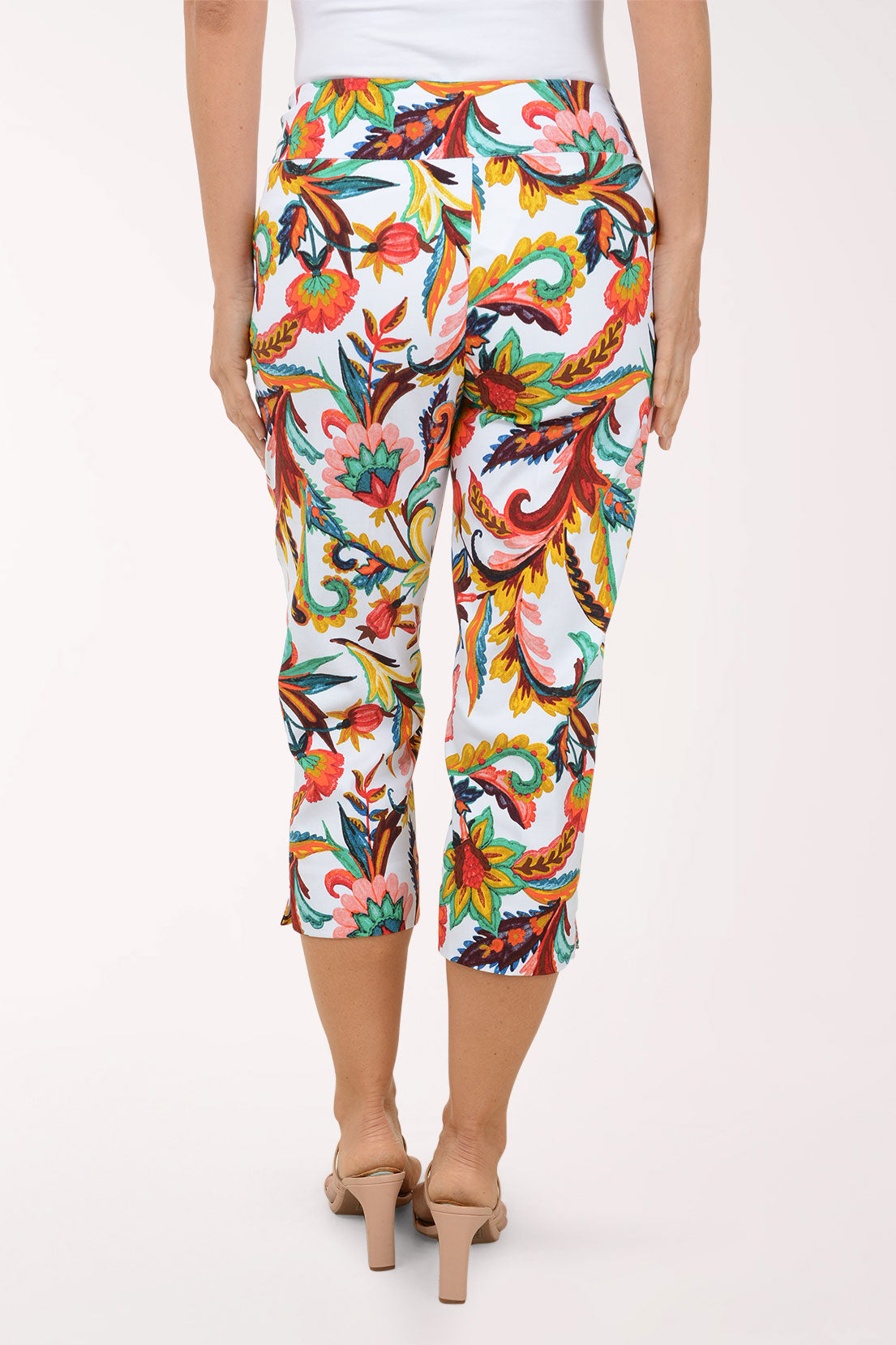 Colorful floral-patterned pants worn by a person on a white background