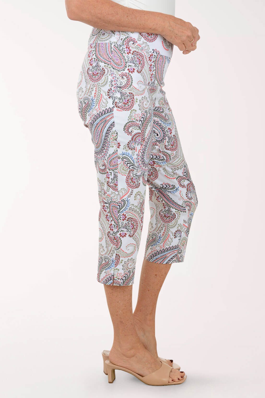 Person wearing a patterned capri pants on a white background