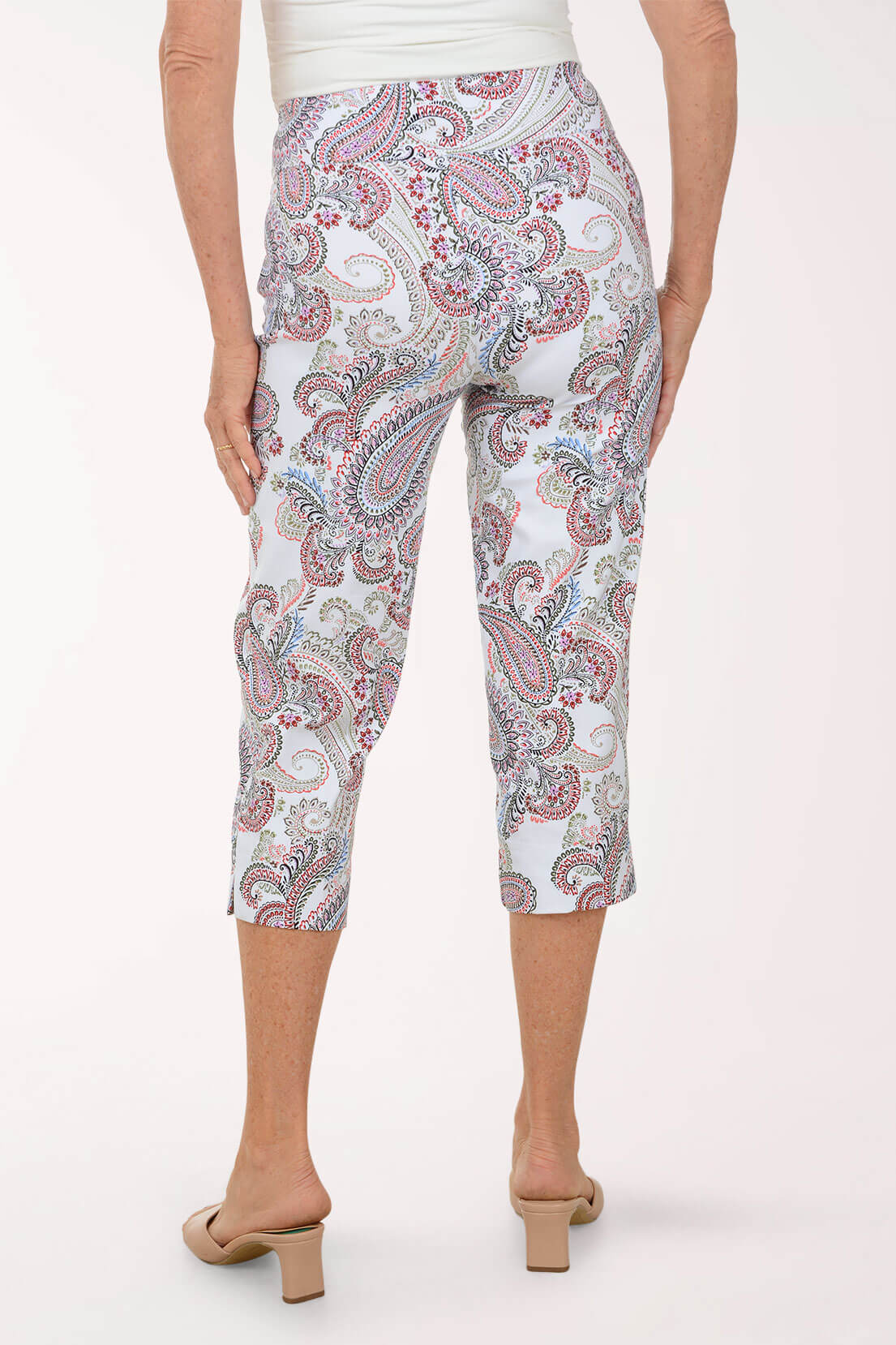 Person wearing a patterned capri pants on a white background