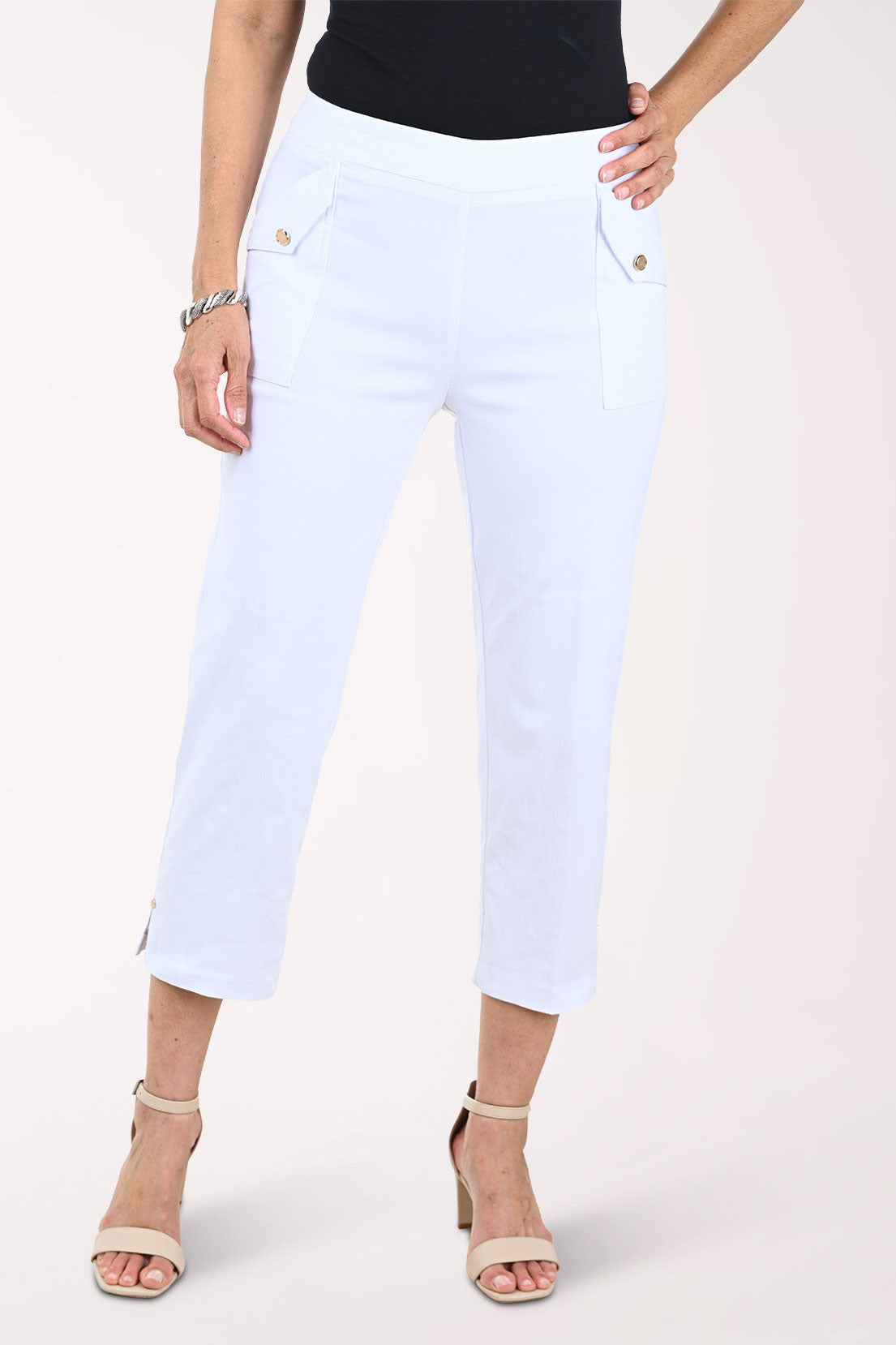 White capri pants worn by a person on a white background