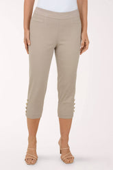 Beige capri pants worn by a person on a white background