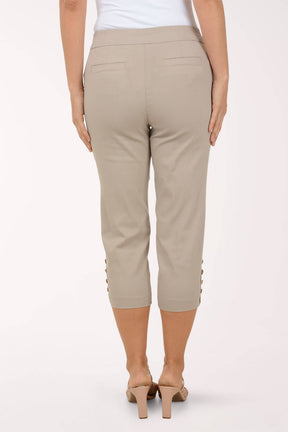 Beige capri pants worn by a person on a white background