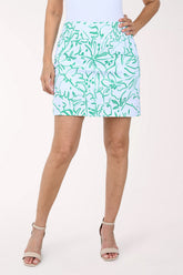 Person wearing a green and white patterned skirt on a white background