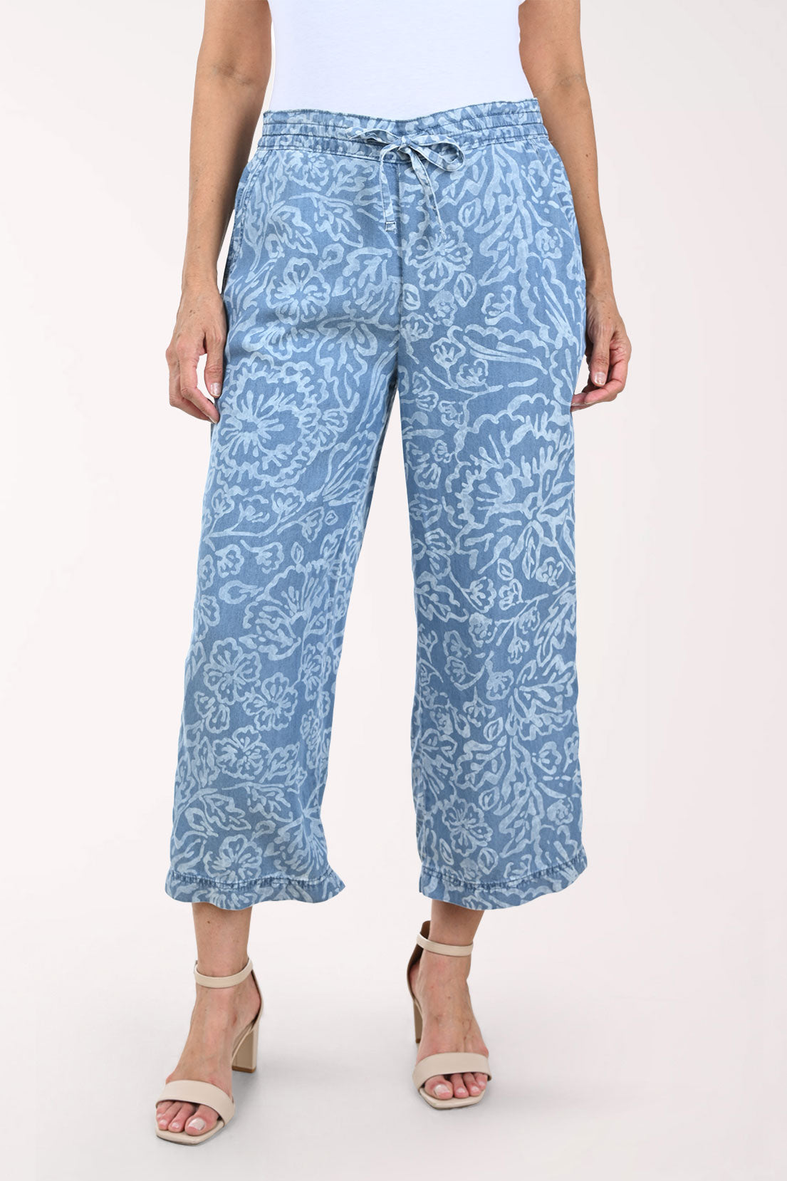 Woman wearing blue patterned pants on a white background
