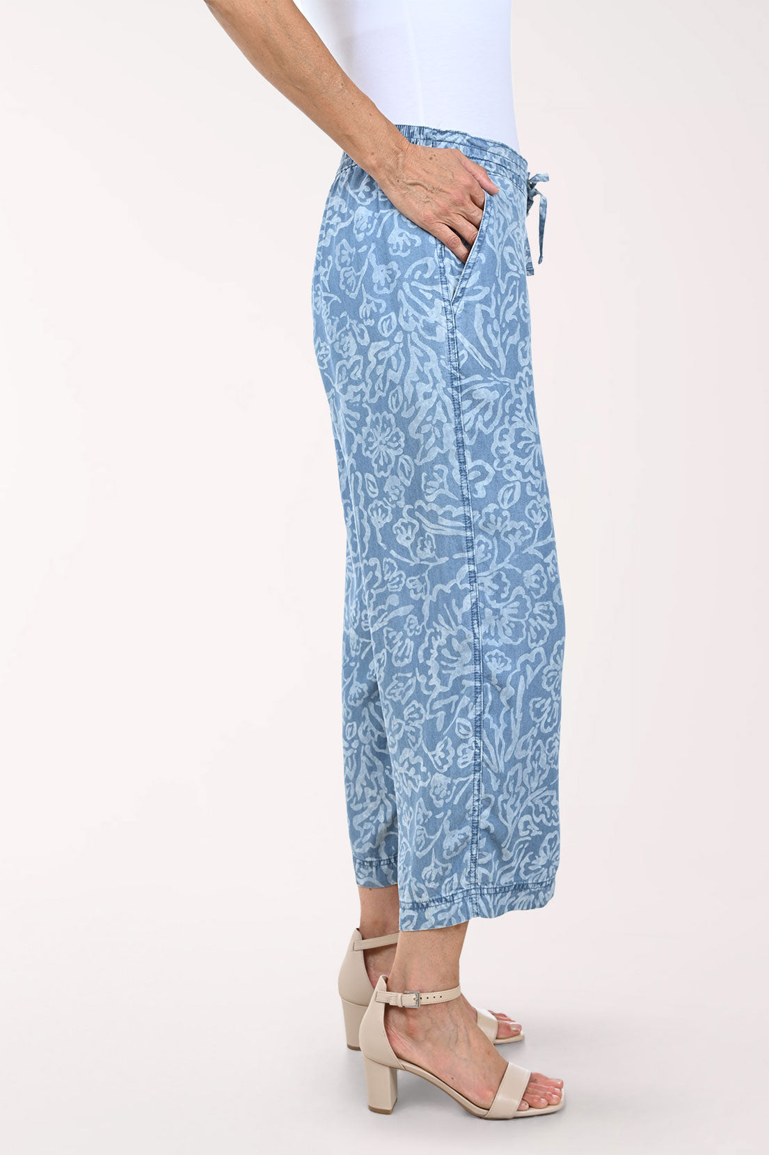 Woman wearing blue patterned pants on a white background