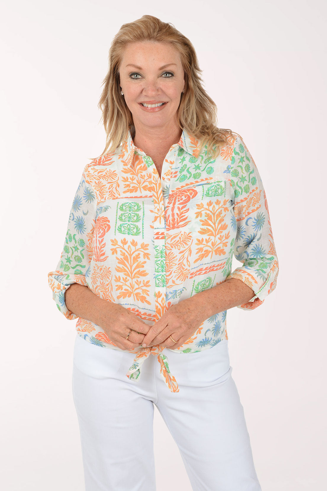 Woman wearing a colorful patterned shirt on a white background