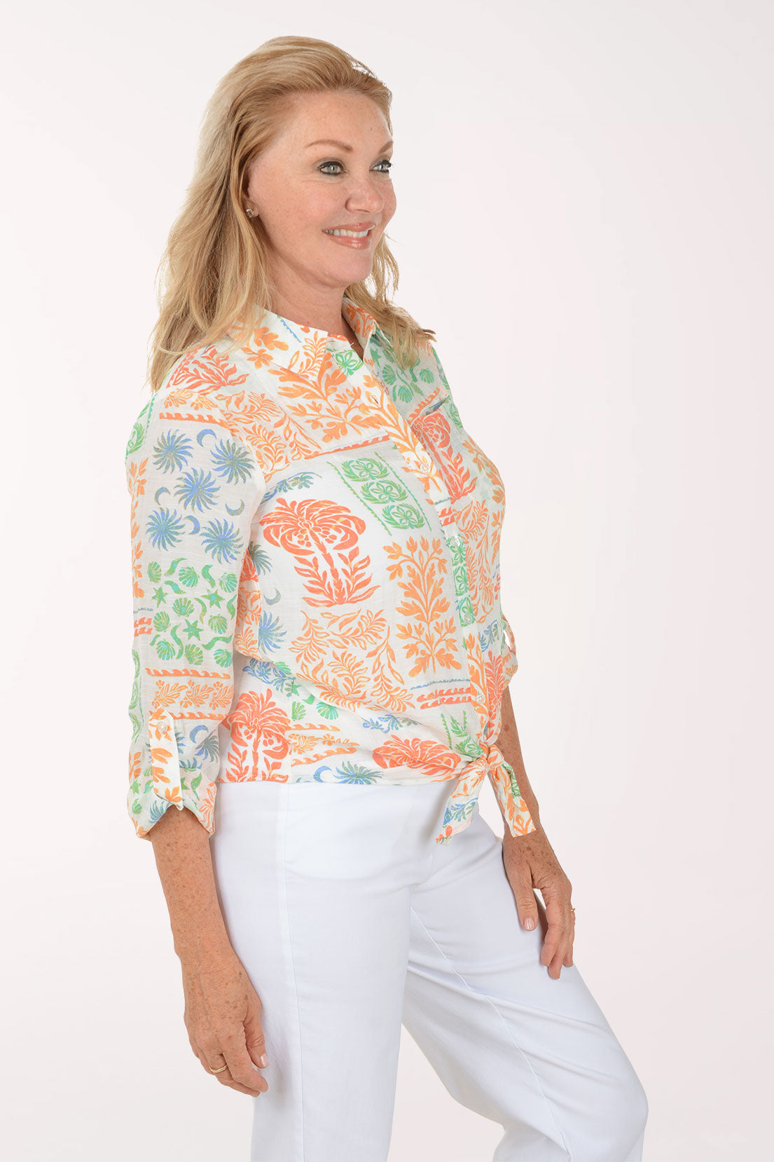 Woman wearing a colorful patterned shirt on a white background